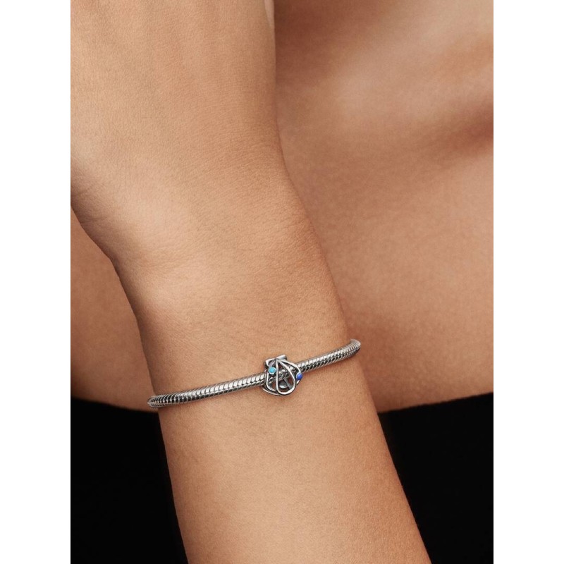 Openwork shell sterling silver charm with blue enamel
